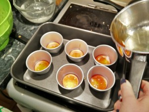Pouring caramel into pudding moulds